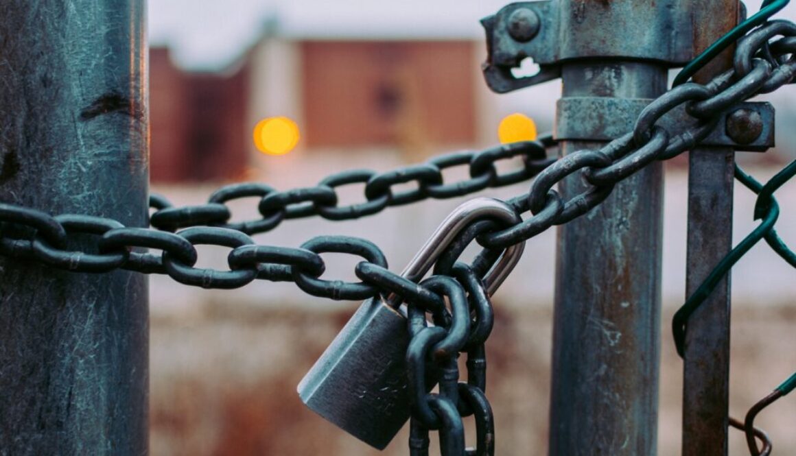 metal gate lock with a padlock and chain