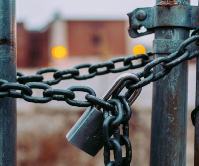 metal gate lock with a padlock and chain